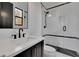 Modern bathroom with a sleek vanity, glass-enclosed shower, and stylish black and white accents at 2875 Caney Parc Way, Cumming, GA 30041