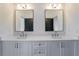 Elegant bathroom features double sinks, modern fixtures and large mirrors at 2875 Caney Parc Way, Cumming, GA 30041