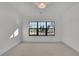 Sun-lit bedroom with carpet, white trim, and a window with a backyard view at 2875 Caney Parc Way, Cumming, GA 30041
