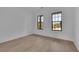 Bedroom featuring hardwood floors, recessed lighting, and large windows providing natural light at 2875 Caney Parc Way, Cumming, GA 30041