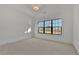 Bright, carpeted bedroom with a large window offering ample natural light at 2875 Caney Parc Way, Cumming, GA 30041