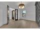 Dining room featuring hardwood floors, a stylish light fixture, and a modern paneled accent wall at 2875 Caney Parc Way, Cumming, GA 30041