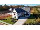 Stately white two-story home with a stone-accented entrance and a three-car garage at 2875 Caney Parc Way, Cumming, GA 30041