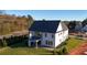 Exterior of a new two-story home featuring a covered patio and freshly laid sod at 2875 Caney Parc Way, Cumming, GA 30041