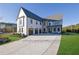 Stunning two-story home with a large driveway and three-car garage at 2875 Caney Parc Way, Cumming, GA 30041