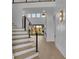 Bright foyer with light wood floors, modern railing and trim, and an open floor plan at 2875 Caney Parc Way, Cumming, GA 30041