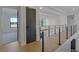 Upstairs hallway with hardwood floors, a wood and metal railing, and natural light at 2875 Caney Parc Way, Cumming, GA 30041