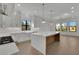 The spacious kitchen features a large island with seating, stainless appliances, and bright natural light at 2875 Caney Parc Way, Cumming, GA 30041
