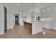 Bright, open kitchen boasts a large island with countertop seating and stainless steel appliances at 2875 Caney Parc Way, Cumming, GA 30041