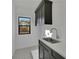 Well-appointed laundry room features a sink, attractive tile flooring, and a window for natural light at 2875 Caney Parc Way, Cumming, GA 30041