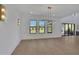 Bright living room with modern chandelier, floor-to-ceiling windows, and hardwood floors at 2875 Caney Parc Way, Cumming, GA 30041
