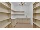 Spacious pantry featuring custom cabinets, floating shelves, and a stylish countertop with a sink at 2875 Caney Parc Way, Cumming, GA 30041