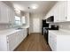 Spacious kitchen features white cabinets and stainless steel appliances at 2910 Treehouse Ln, Lawrenceville, GA 30044