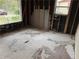Bedroom with removed walls, two large windows, and damaged flooring at 6127 Pinegrove Rd, Riverdale, GA 30274