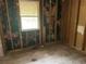 Bedroom showing exposed framework, window and hardwood floor ready for renovation and customization at 6127 Pinegrove Rd, Riverdale, GA 30274