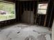 Bedroom with removed walls, two large windows, and damaged flooring at 6127 Pinegrove Rd, Riverdale, GA 30274