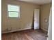 Bedroom with original hardwood floors, window and a closet, ready for updates and personalization at 6127 Pinegrove Rd, Riverdale, GA 30274
