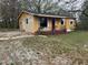 Charming, single-story home with a red front door and a partially landscaped front yard at 6127 Pinegrove Rd, Riverdale, GA 30274