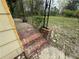 Exterior of a brick porch with wrought iron railing and grassy yard at 6127 Pinegrove Rd, Riverdale, GA 30274