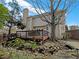 Backyard view of home with a wooden deck, hot tub, pond and mature landscaping at 2123 Tigger Ne Trce, Marietta, GA 30066