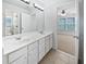 Well-lit bathroom features a double sink vanity and views into the connecting bedroom at 2123 Tigger Ne Trce, Marietta, GA 30066