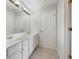 Bright bathroom featuring double sinks, large mirror, and tiled floors at 2123 Tigger Ne Trce, Marietta, GA 30066