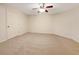 A large bedroom featuring neutral carpeting, a ceiling fan, and a closet door at 2123 Tigger Ne Trce, Marietta, GA 30066