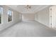 Large bedroom featuring tray ceilings, ceiling fan, and windows allowing for ample natural light at 2123 Tigger Ne Trce, Marietta, GA 30066