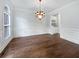 Formal dining room with hardwood floors, wainscoting, and decorative lighting fixture at 2123 Tigger Ne Trce, Marietta, GA 30066