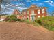 A stunning two-story brick home with a well-manicured front lawn and mature landscaping at 2123 Tigger Ne Trce, Marietta, GA 30066