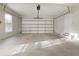 Bright garage with new epoxy floor, window and pedestrian door to the house at 2123 Tigger Ne Trce, Marietta, GA 30066