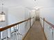 Upstairs hallway features wood and white railings and decorative light fixtures at 2123 Tigger Ne Trce, Marietta, GA 30066