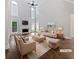 Staged living room with high ceilings, a fireplace, lots of natural light, and hardwood floors at 2123 Tigger Ne Trce, Marietta, GA 30066
