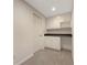 A home office space with built in shelves, cabinets and desk with neutral carpeting at 2123 Tigger Ne Trce, Marietta, GA 30066