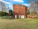 Back of home featuring a two-story brick exterior, garage, and lawn at 2123 Tigger Ne Trce, Marietta, GA 30066