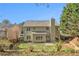 Large backyard featuring a well-maintained lawn, mature trees, and a charming patio at 3707 Mcguire Nw St, Kennesaw, GA 30144