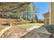 The backyard features a patio and retaining wall, blending outdoor living with nature's beauty at 3707 Mcguire Nw St, Kennesaw, GA 30144