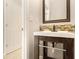 Powder room featuring a mirror, vanity, vessel sink with stylish mosaic tile backsplash, and white doors at 3707 Mcguire Nw St, Kennesaw, GA 30144