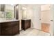 Double vanity bathroom with dark wood cabinets and contemporary finishes at 3707 Mcguire Nw St, Kennesaw, GA 30144