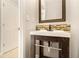 Modern bathroom vanity with sleek fixtures, decorative mirror, and tiled backsplash at 3707 Mcguire Nw St, Kennesaw, GA 30144