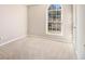 Bedroom with arched window features soft carpet and neutral paint scheme at 3707 Mcguire Nw St, Kennesaw, GA 30144