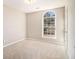 Carpeted bedroom with a large window and natural light at 3707 Mcguire Nw St, Kennesaw, GA 30144