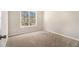 Bright bedroom features neutral carpet, fresh paint, and a large window with a backyard view at 3707 Mcguire Nw St, Kennesaw, GA 30144