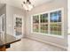 Sunny breakfast nook featuring large windows and a door with glass panels, plus neutral paint at 3707 Mcguire Nw St, Kennesaw, GA 30144