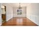 Elegant dining room with hardwood floors, wainscoting, and a decorative chandelier at 3707 Mcguire Nw St, Kennesaw, GA 30144