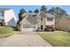 Charming two-story home features a stone accent facade, light siding, and attached garage at 3707 Mcguire Nw St, Kennesaw, GA 30144