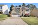 Charming two-story home with a stone accent and well-manicured lawn at 3707 Mcguire Nw St, Kennesaw, GA 30144