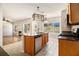 Open-concept kitchen with island overlooking living room, featuring stainless appliances, granite counters and tile floors at 3707 Mcguire Nw St, Kennesaw, GA 30144
