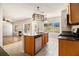 Open-concept kitchen featuring stainless steel appliances, an island, and views of living space at 3707 Mcguire Nw St, Kennesaw, GA 30144