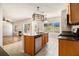 Open kitchen with granite island, stainless appliances, and views to the living room and backyard at 3707 Mcguire Nw St, Kennesaw, GA 30144